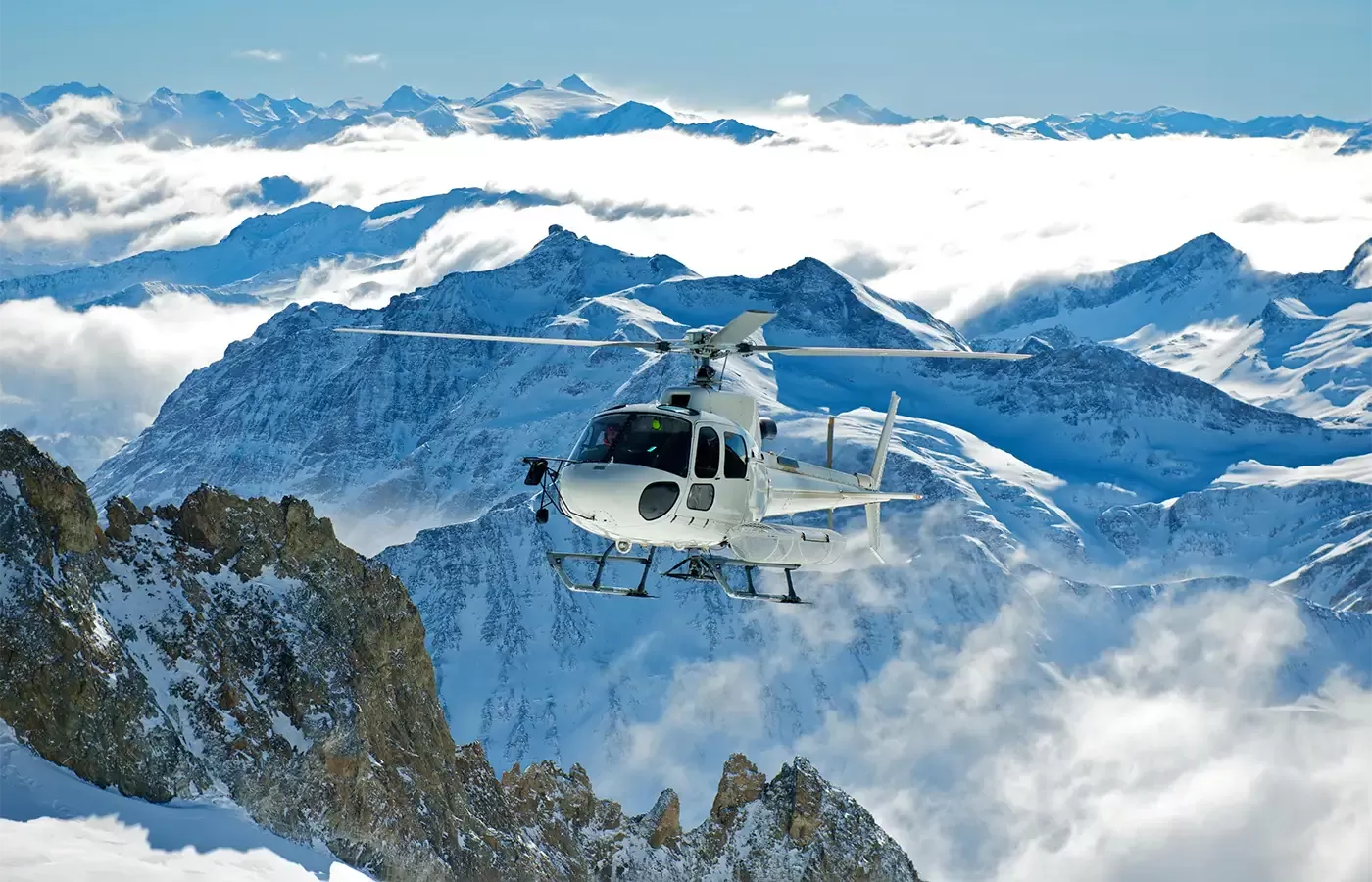 Helicopter over icy mountains in Alaska