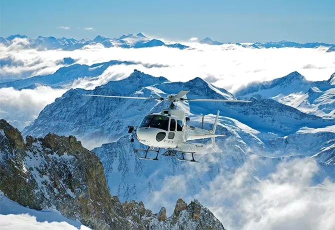 Helicopter over icy mountains in Alaska
