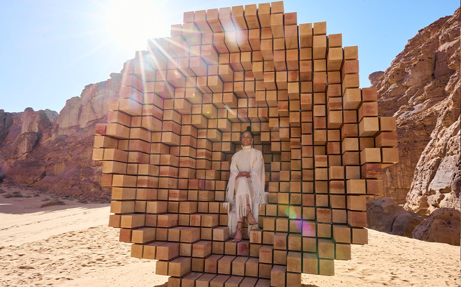 Alicia Keys sat in a large 3D wooden sculpture in the desert