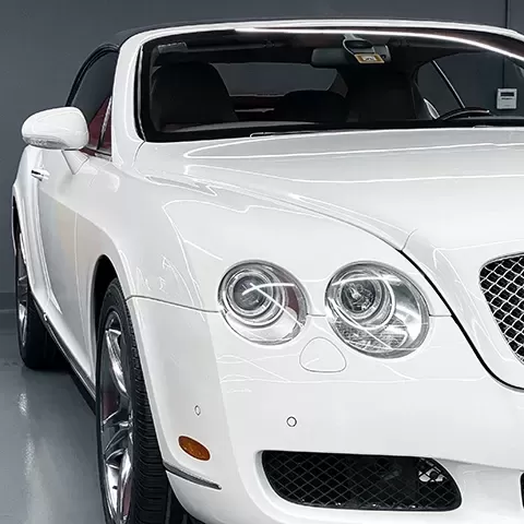 Front of white convertible Bentley
