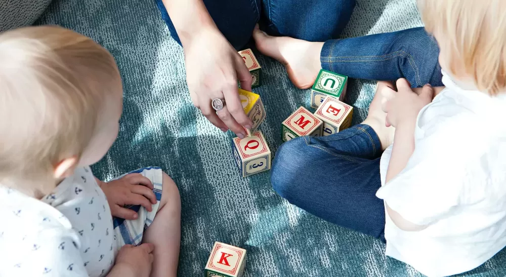 Children sat down playing with blocks