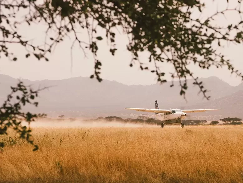 Private jet landing in Tanzania landscape | Quintessentially Weddings