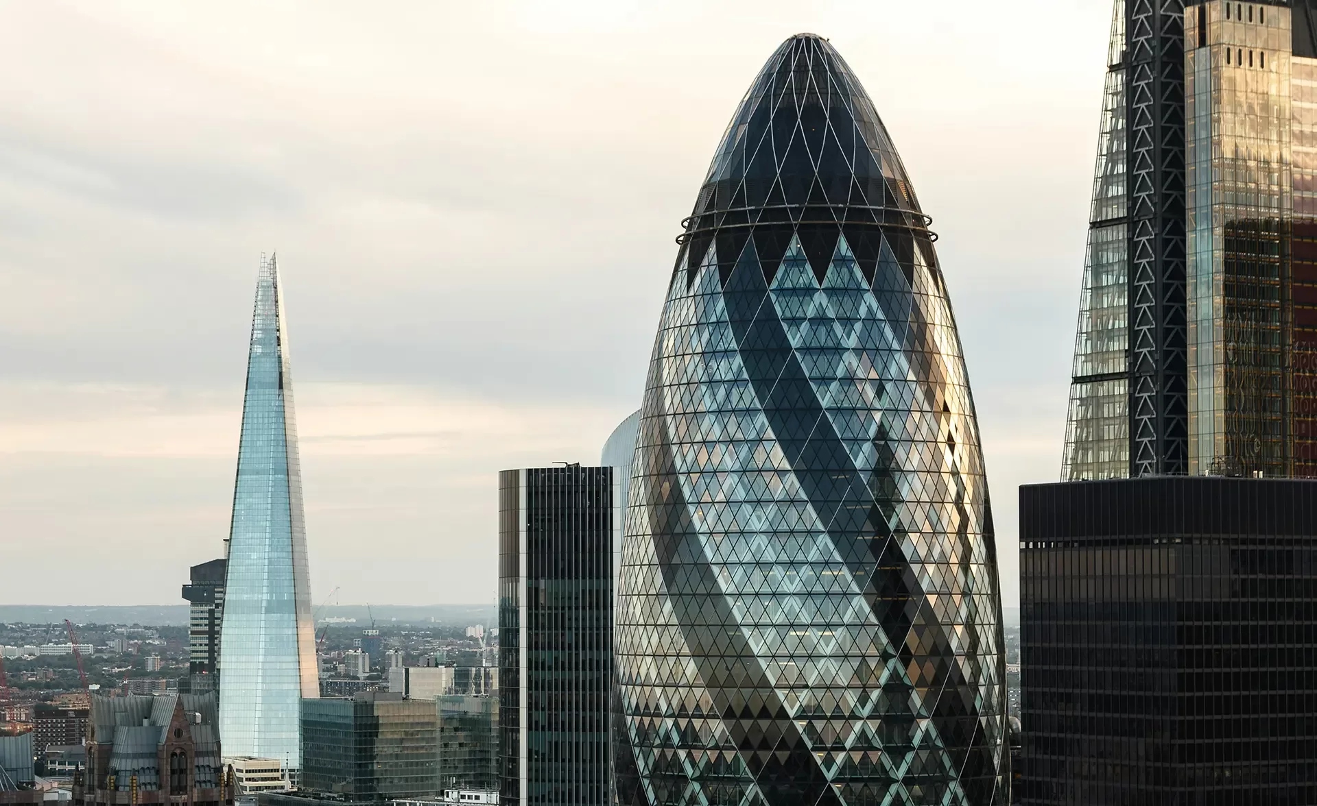 London city skyline showcasing the top of the Shard and Gherkin landmarks.