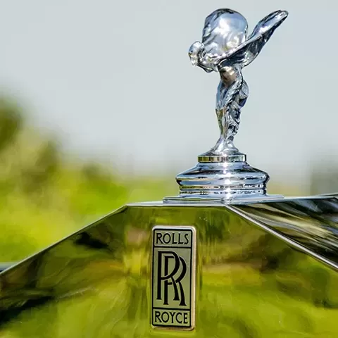Front of silver Rolls Royce car with branded bonnet ornament