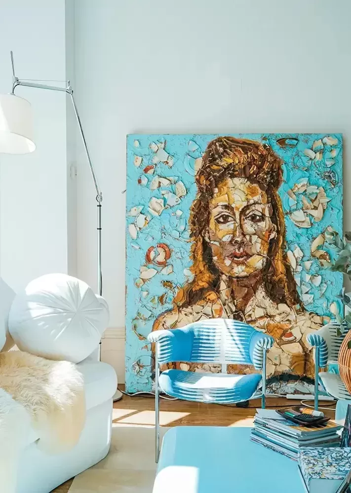 A painting of a woman elegantly displayed on a wall, showcasing artistic details and vibrant colors.