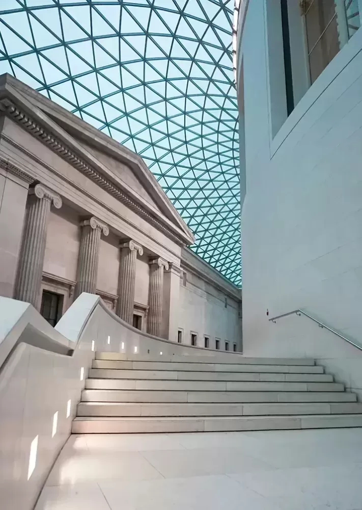 The grand interior of the British Museum's Great Hall, showcasing its impressive architecture and historical artifacts.