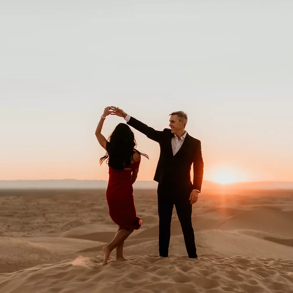 Mature couple dancing in the dessert copy