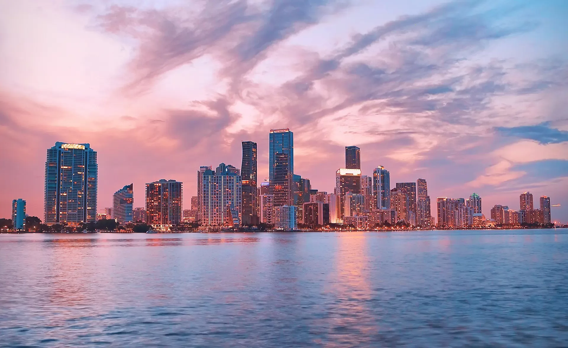 Beautiful pink-tinted Miami skyline with the sky filled with shades of pink.