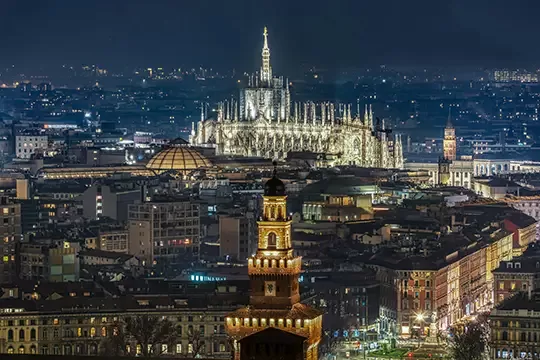 Birdseye view of Milan city lit up at night, Italy