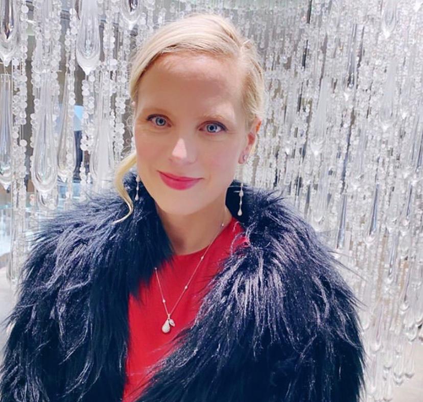 Profile shot of women wearing blue feather coat