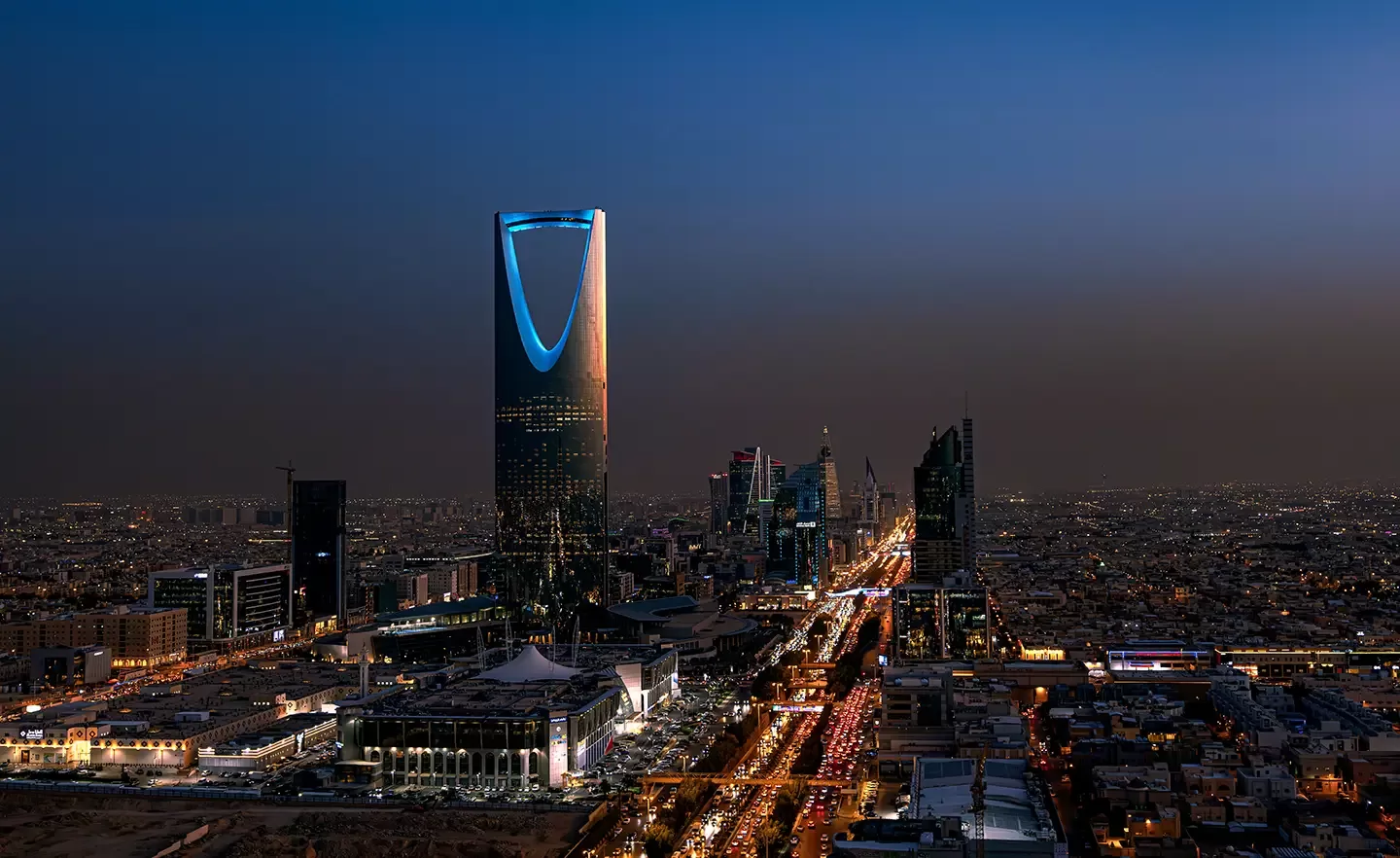 Birdseye view of Riyadh city skyline with building lit up at night in Riyadh, Saudi Arabia