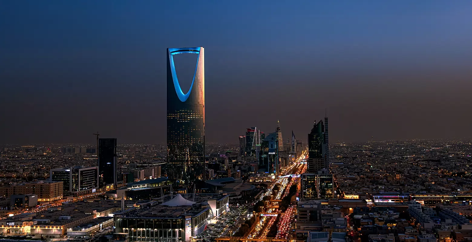 Birdseye view of Riyadh city skyline with building lit up at night in Riyadh, Saudi Arabia