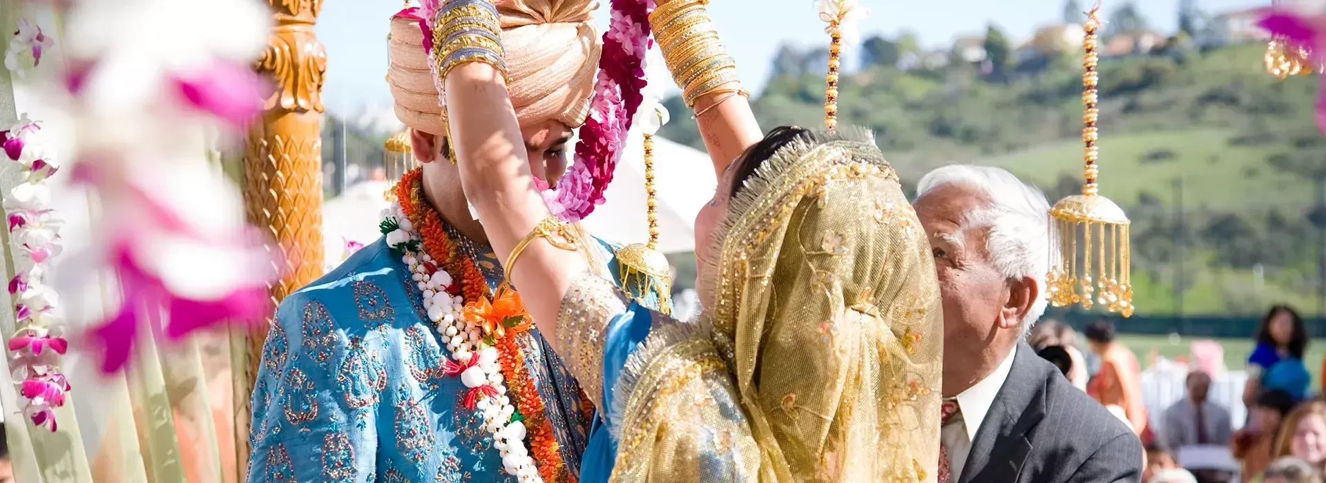 Bride and groom at Indian wedding in traditional dress with beautiful colourful decor