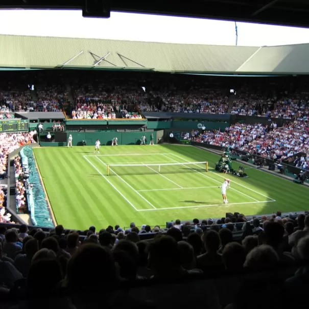 View of a live Wimbledon tennis match between players from the audience.