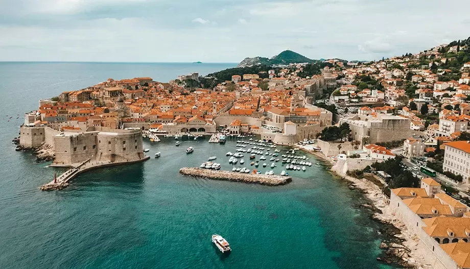 Birdseye view of sea, rocks, boats and ciy of Dubrovnik, Croatia