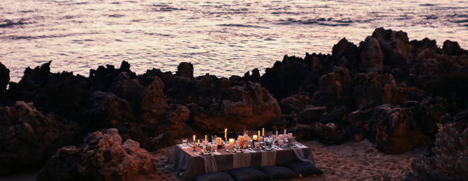 Candlelit bespoke dinner set up on a beach front