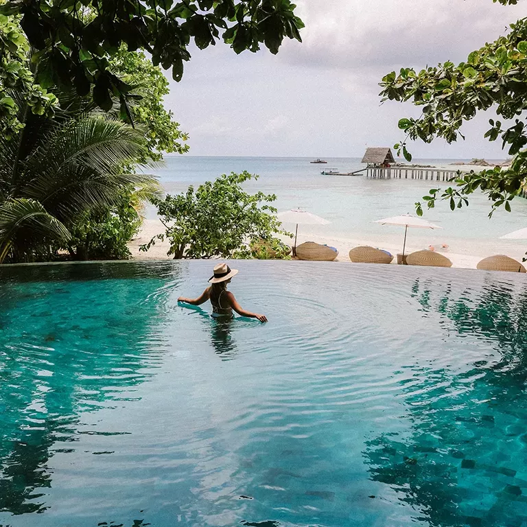 Women in the pool looking at sea view
