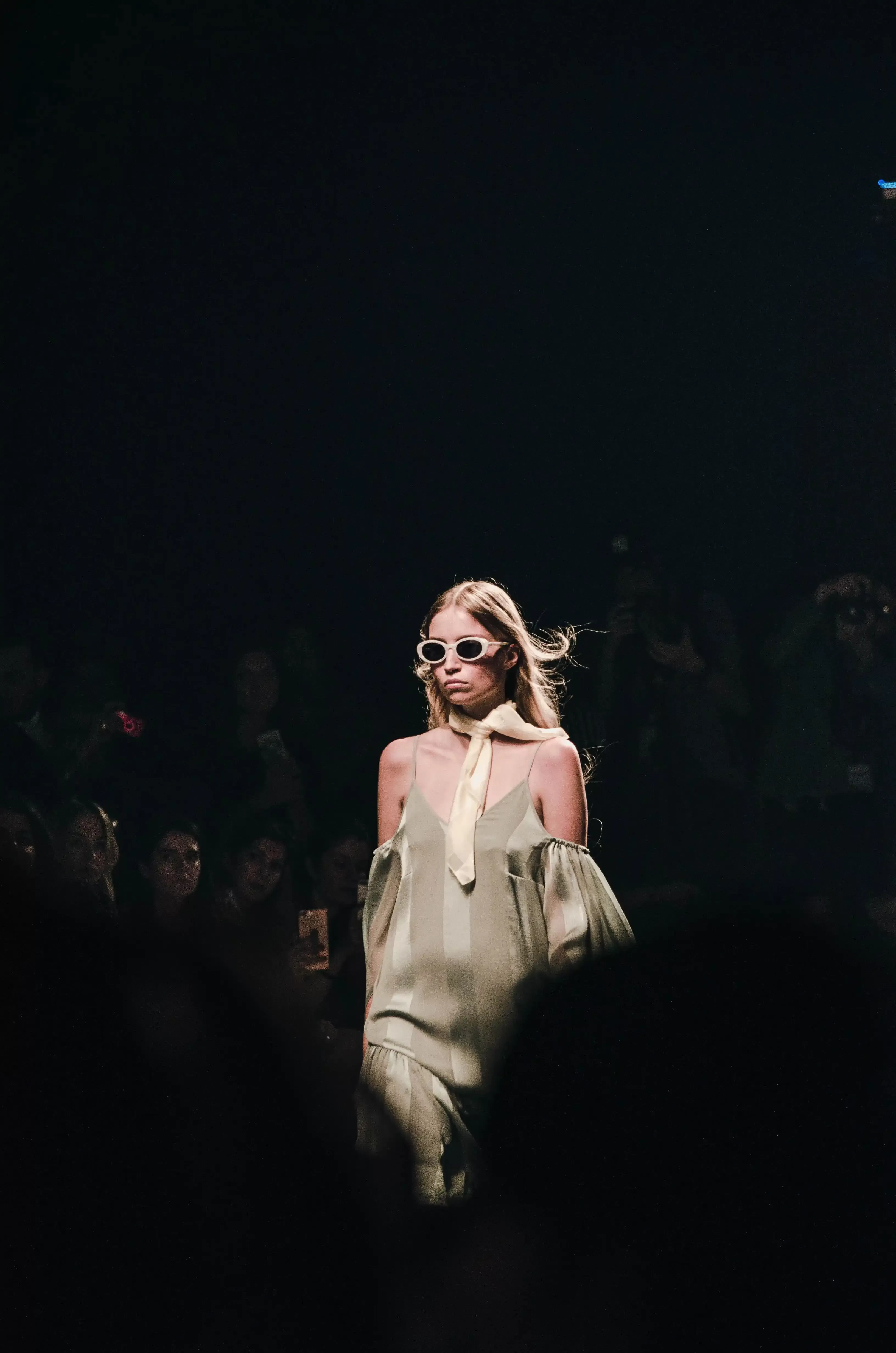 Model wearing high fashion walking down catwalk