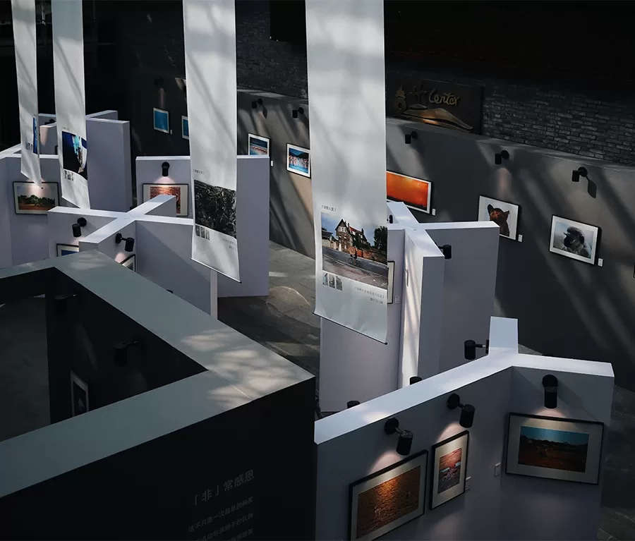 A large room featuring an array of pictures on the walls, enhancing the visual appeal of the space.