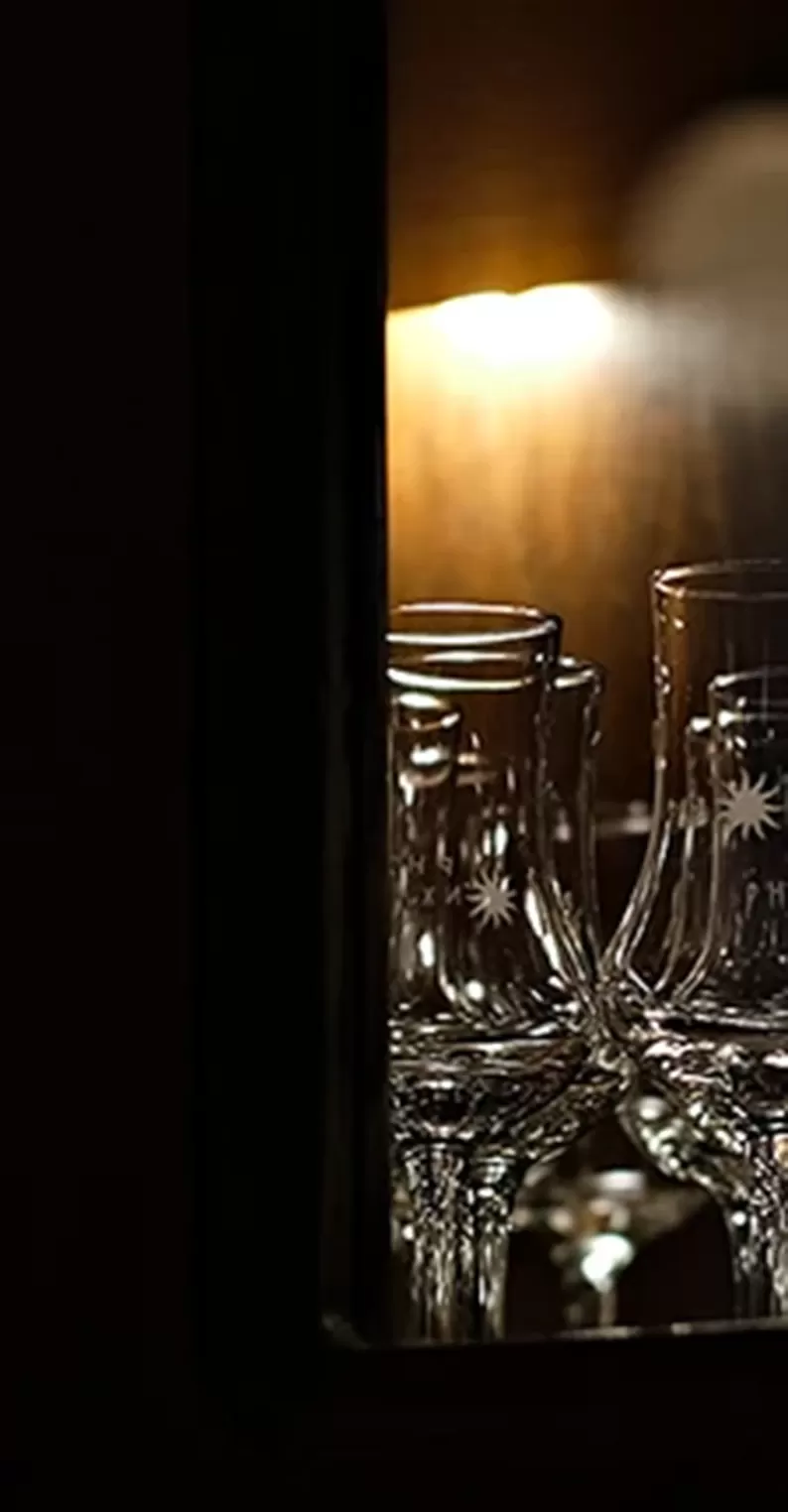 Cabinet of Hennessy glasses.