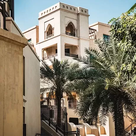Tall stone buildings and trees in Dubai