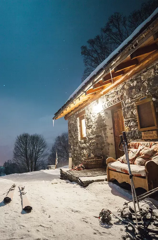 Nighttime outside a snowy cabin