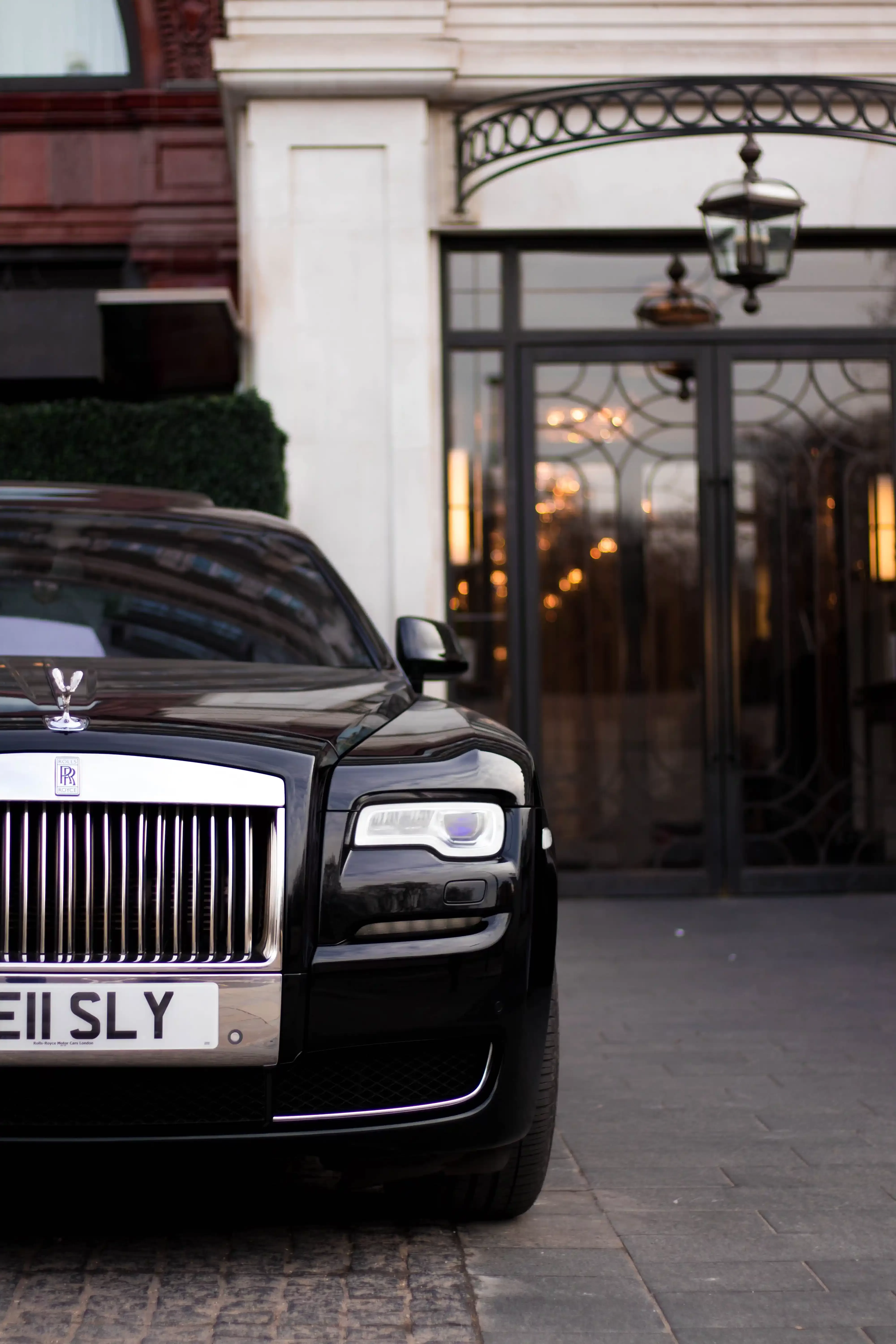 Front of Rolls Royce parked in front of building entrance