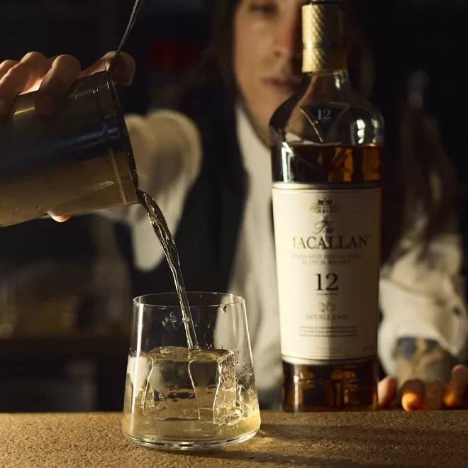 A person pouring liquid into a glass.