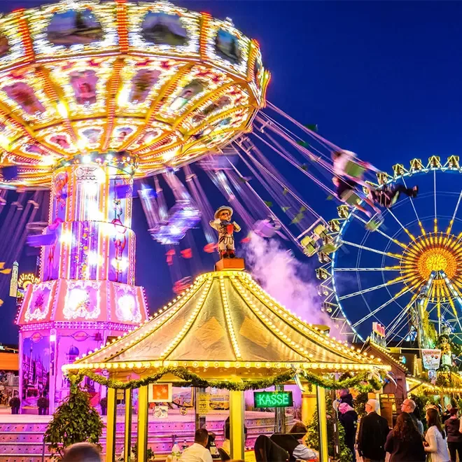 Carnival rides in action at Oktoberfest, Munich at night.