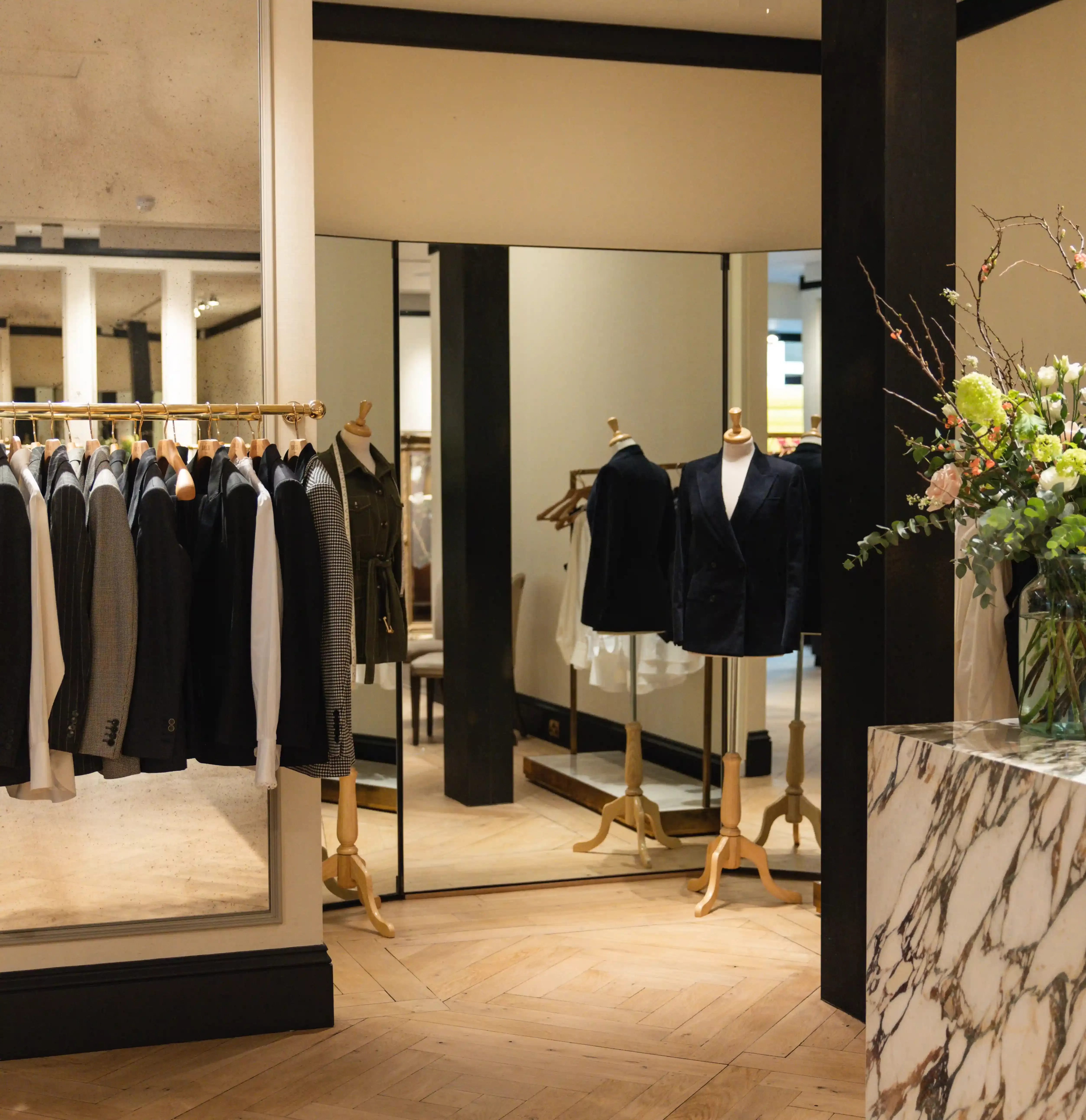 Interior of The Deck's new shopfront at no. 32 Savile Row with boutique style store and rails of clothing