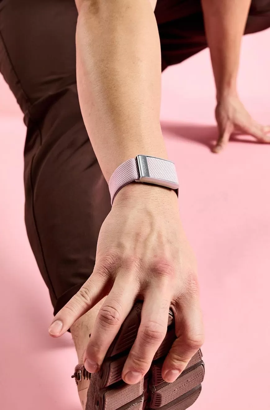 Person stretching their leg wearing a wearable tech watch