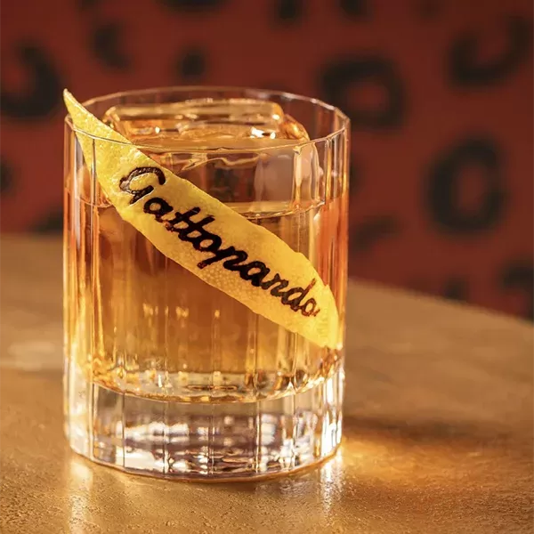 Secret recipe negroni cocktail served with a branded garnish at Il Gattopardo in London, Mayfair