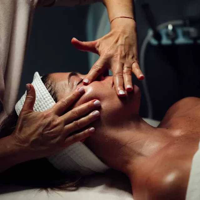 Women in towel robes receiving a facial by Joanna Czech
