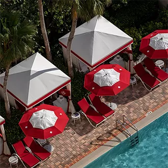 Birds eye view of red and white pool loungers and swimming pool