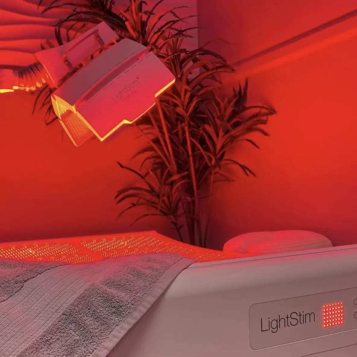 Red lit room with beauty treatment bed