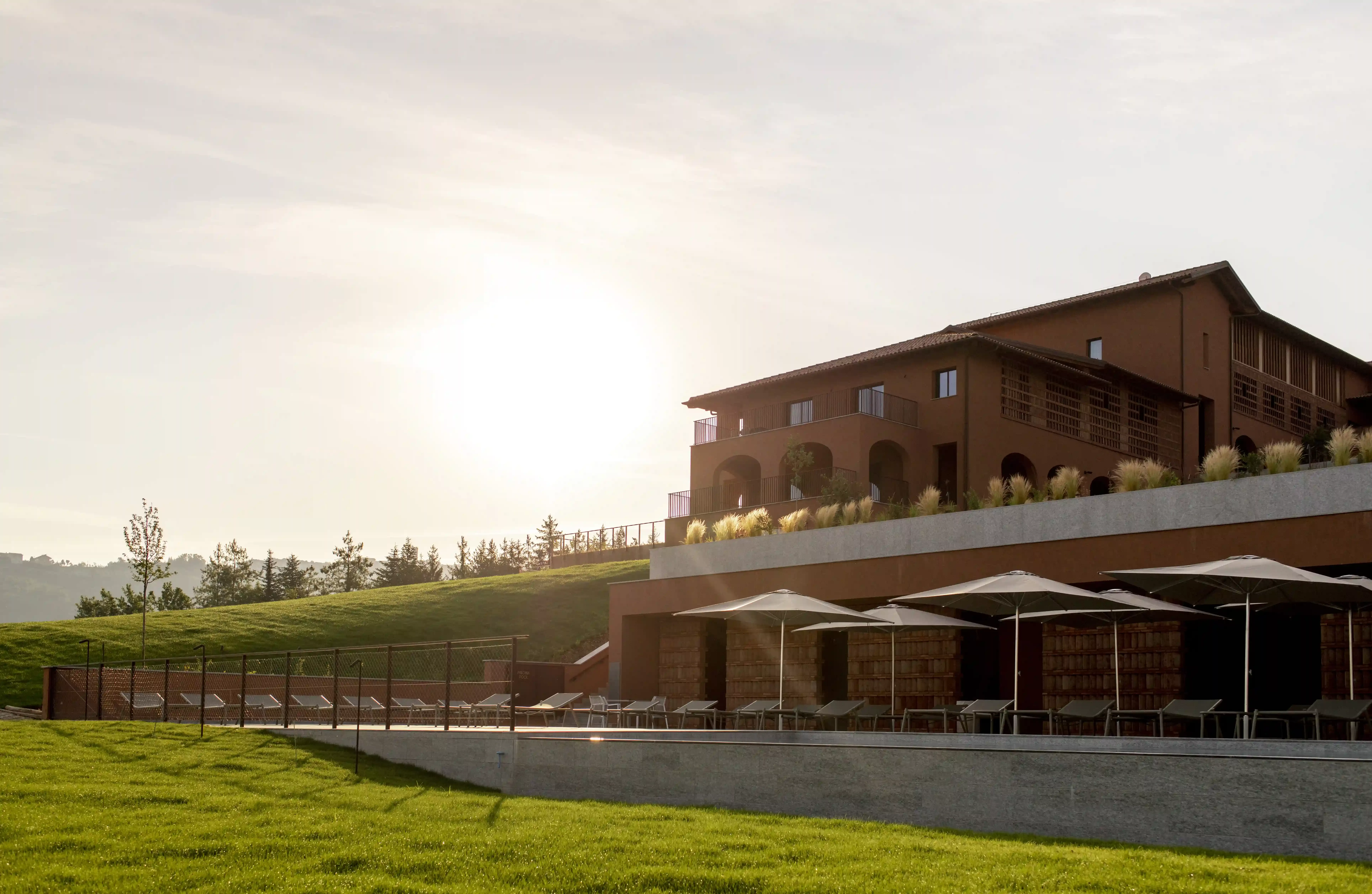 Exterior of grand red building of Casa Di Langa in the Langhe Hills, overlooking 100 acres of its own vineyards, Piedmont