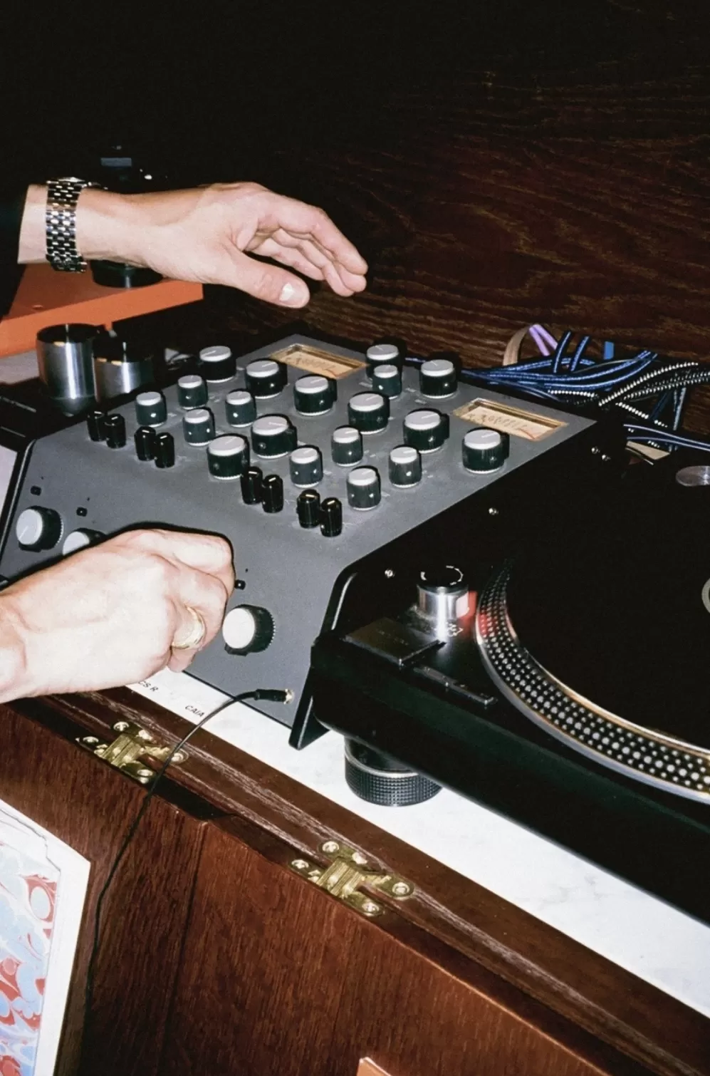 Person playing with vintage stereo deck at Caia, Notting Hill