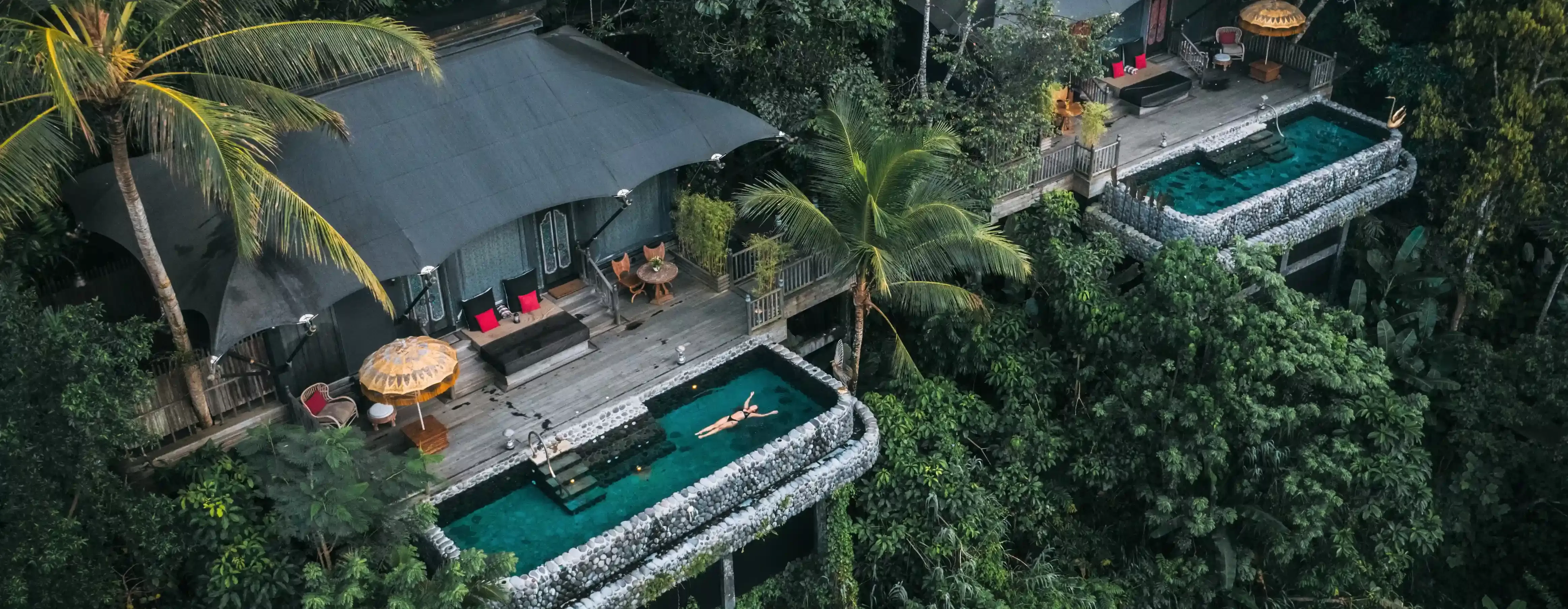 Birdseye view of luxury lodges with tree top pools at Capella Ubud, Bali