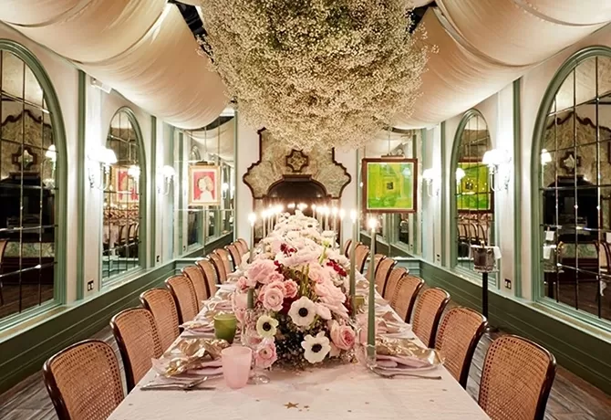 Luxury long dining table decorated with flowers at Daphn, Chelsea, London