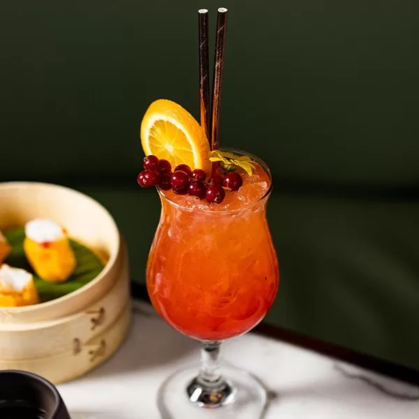Selection of dim sum in a bamboo steamer and a cocktail at Dim Sum Terrace at Harrods, Knightsbridge, London