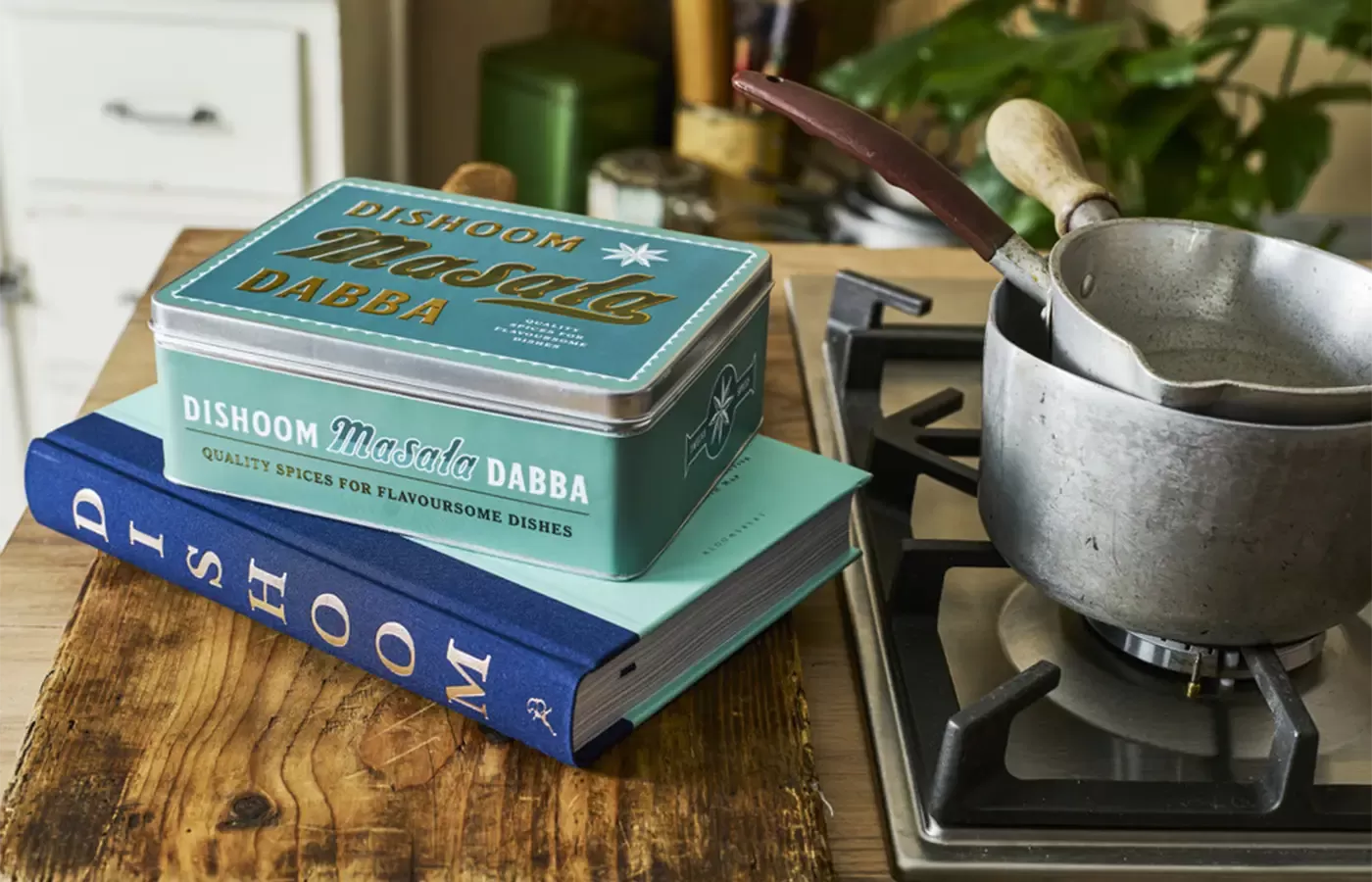Dishoom cooking books next to a hob.