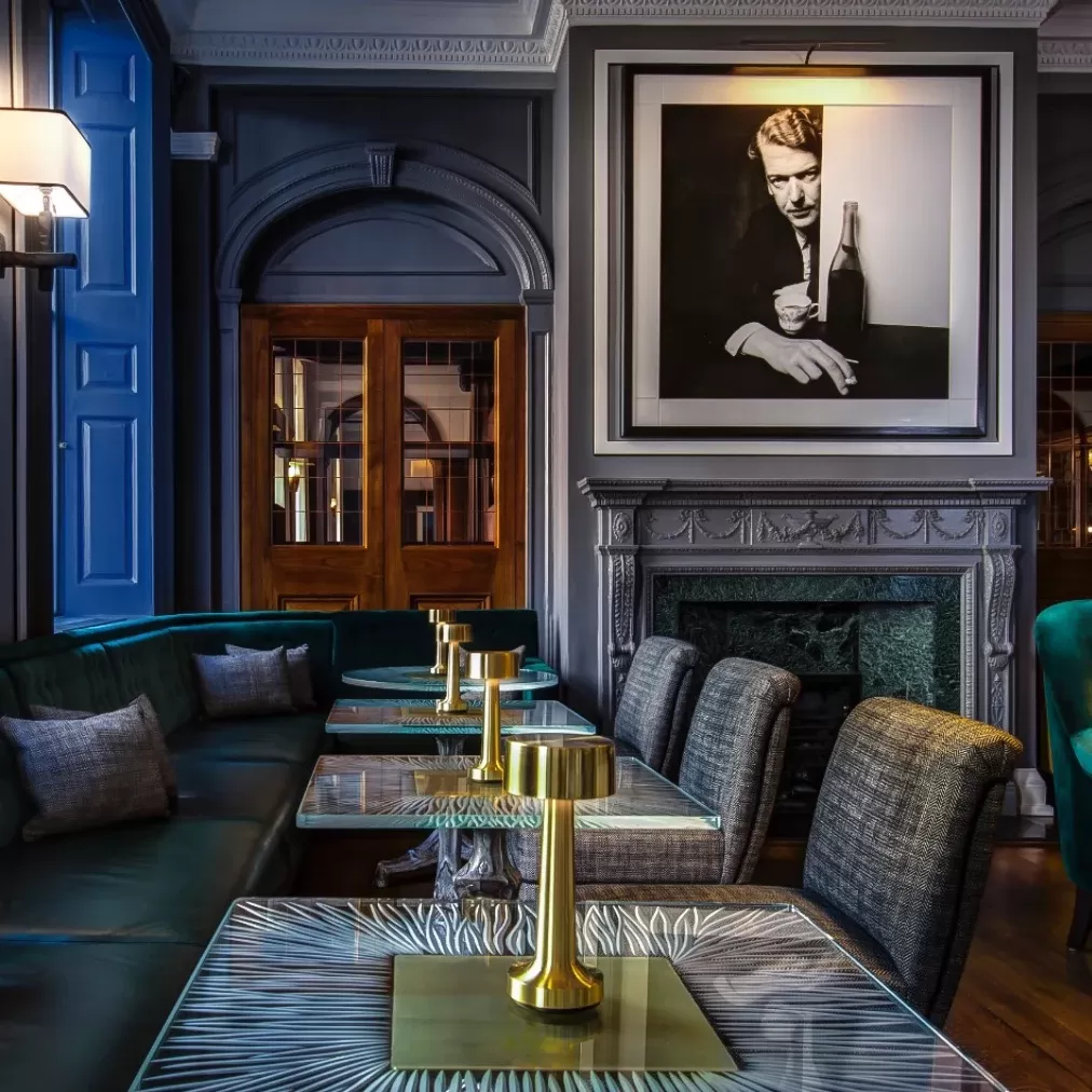 Photography filled blue tone interior at Donovan Bar, Mayfair, London