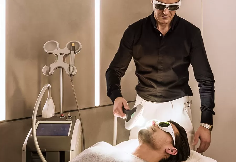 Dr Costas Papageorgiou, MD FACS at Harrods Wellness Clinic delivering facial treatment EmScult at EmFcace