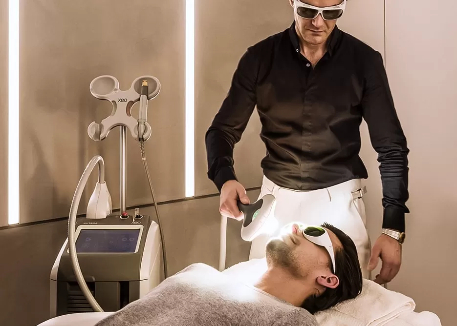 Dr Costas Papageorgiou, MD FACS at Harrods Wellness Clinic delivering facial treatment EmScult at EmFcace