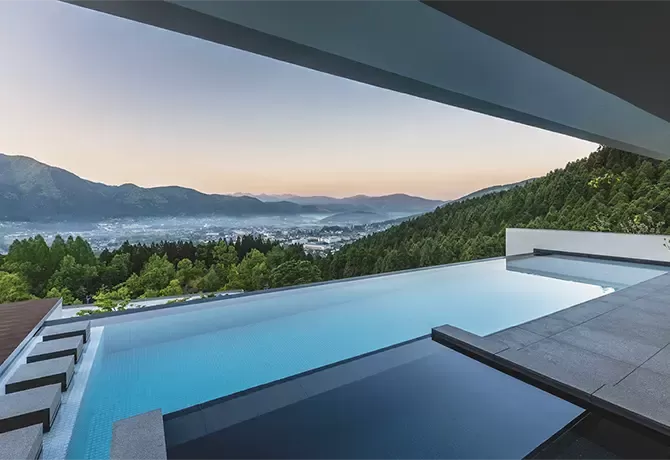 Hillside luxury resort pool with view at Enowa in Yufuin, Japan
