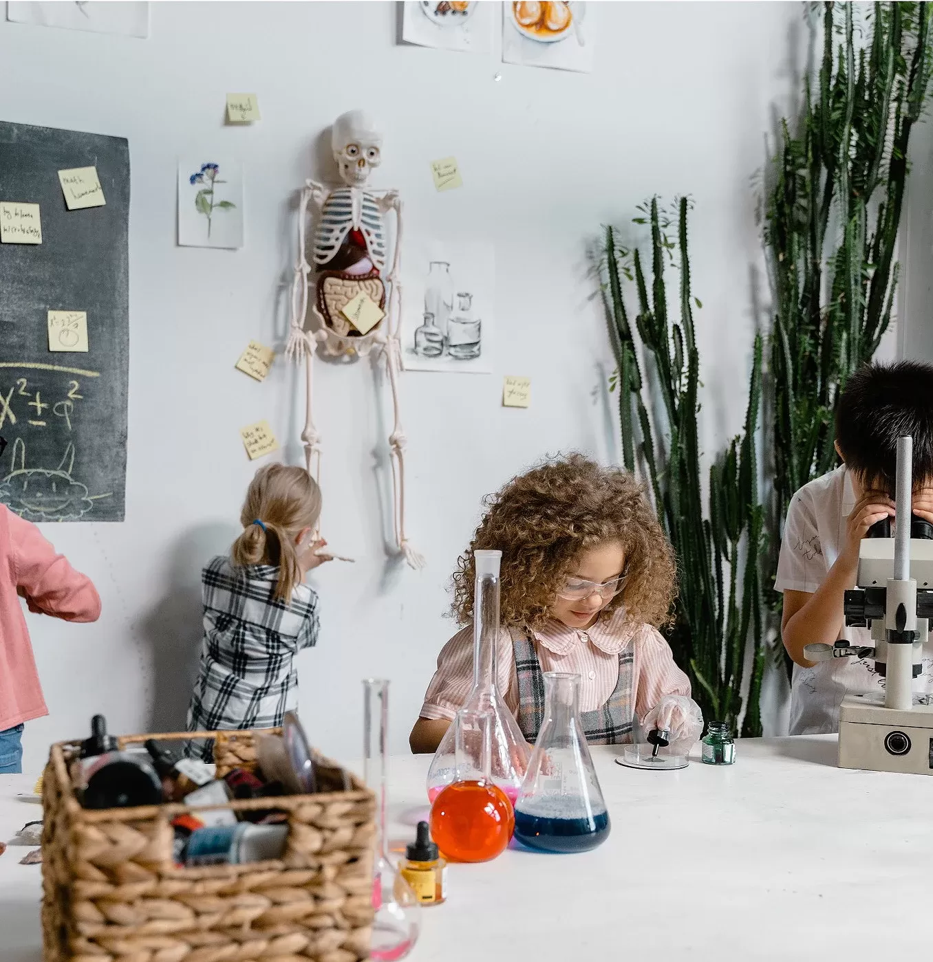 Children with science equipment in a classroom experimenting