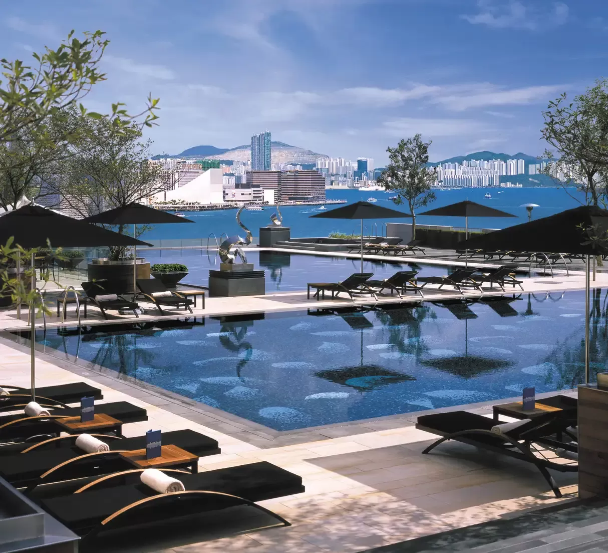 Outside pool and sunbeds overlooking Hong Kong city