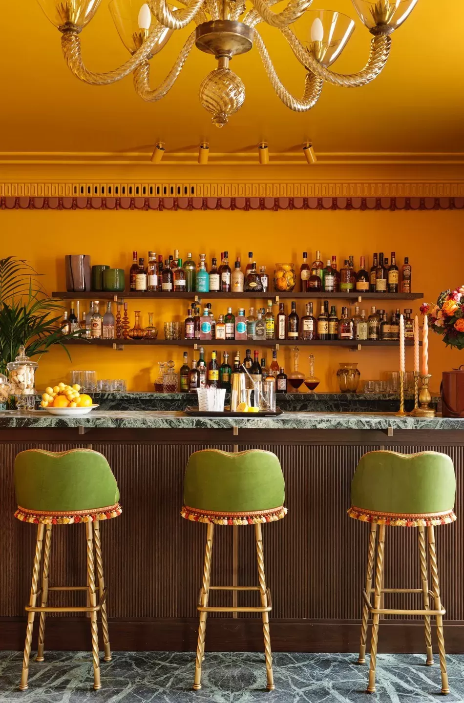 Sunshine yellow Italian Room with yellow walls and contrast green bar stools at Mount St. Restaurant, Mayfair, London