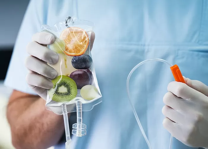 Doctor holding IV drip full of fruit