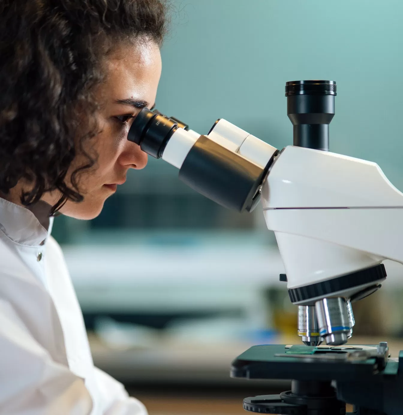 Women looking through microscope at Imperial College London: Global Summer School